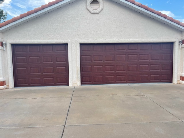 Dual brown garage doors with tiled floor.