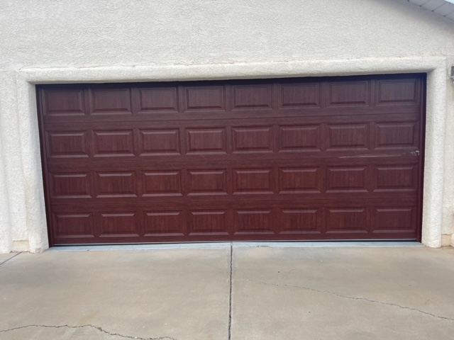 A brown garage door with a white trim, adding a touch of elegance to the exterior of a house.