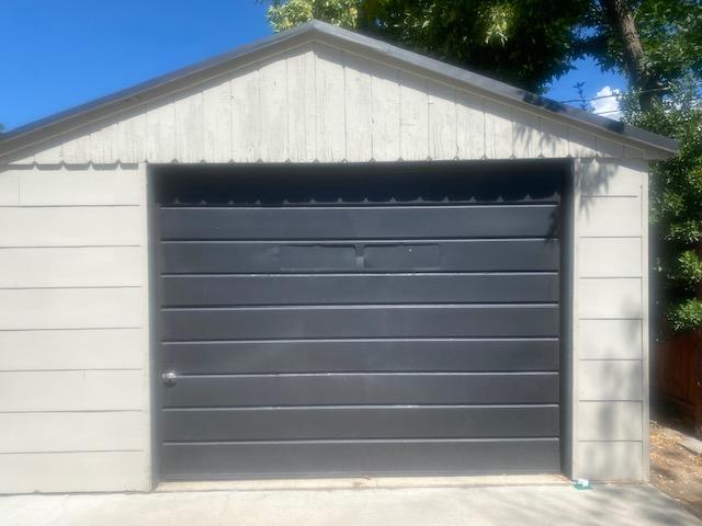 Gray garage with black garage door
