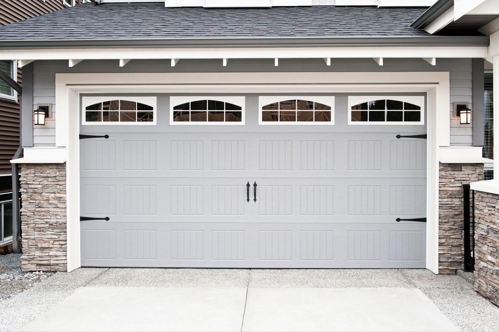 A gray garage door with windows, perfect for garage door replacement or getting a new garage door.