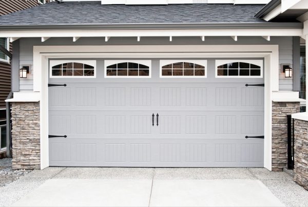 Gray garage door with windows, perfect for garage door replacement or repair services.