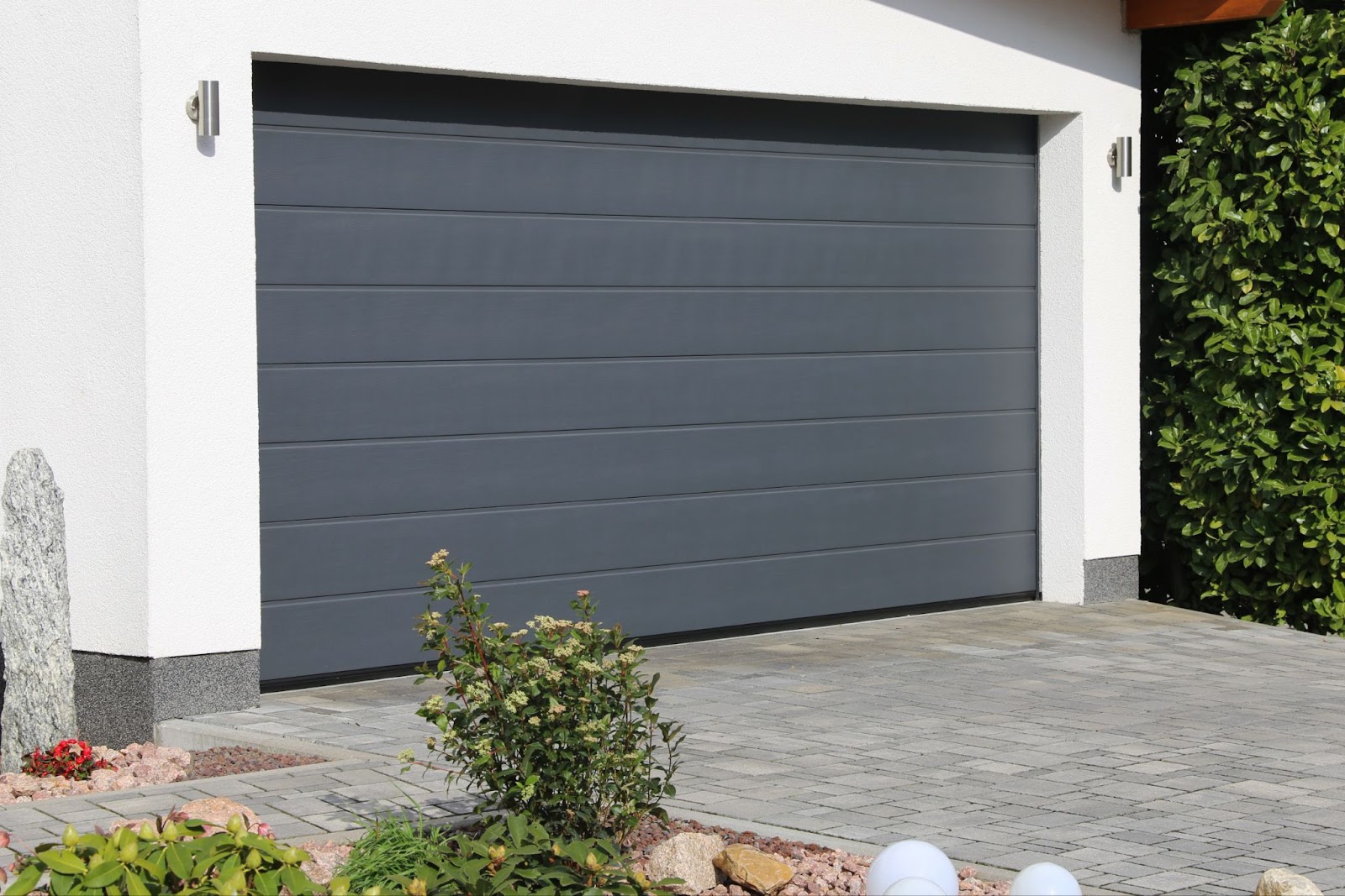 A gray garage door in good condition, highlighting its functionality and potential for repair if issues arise.