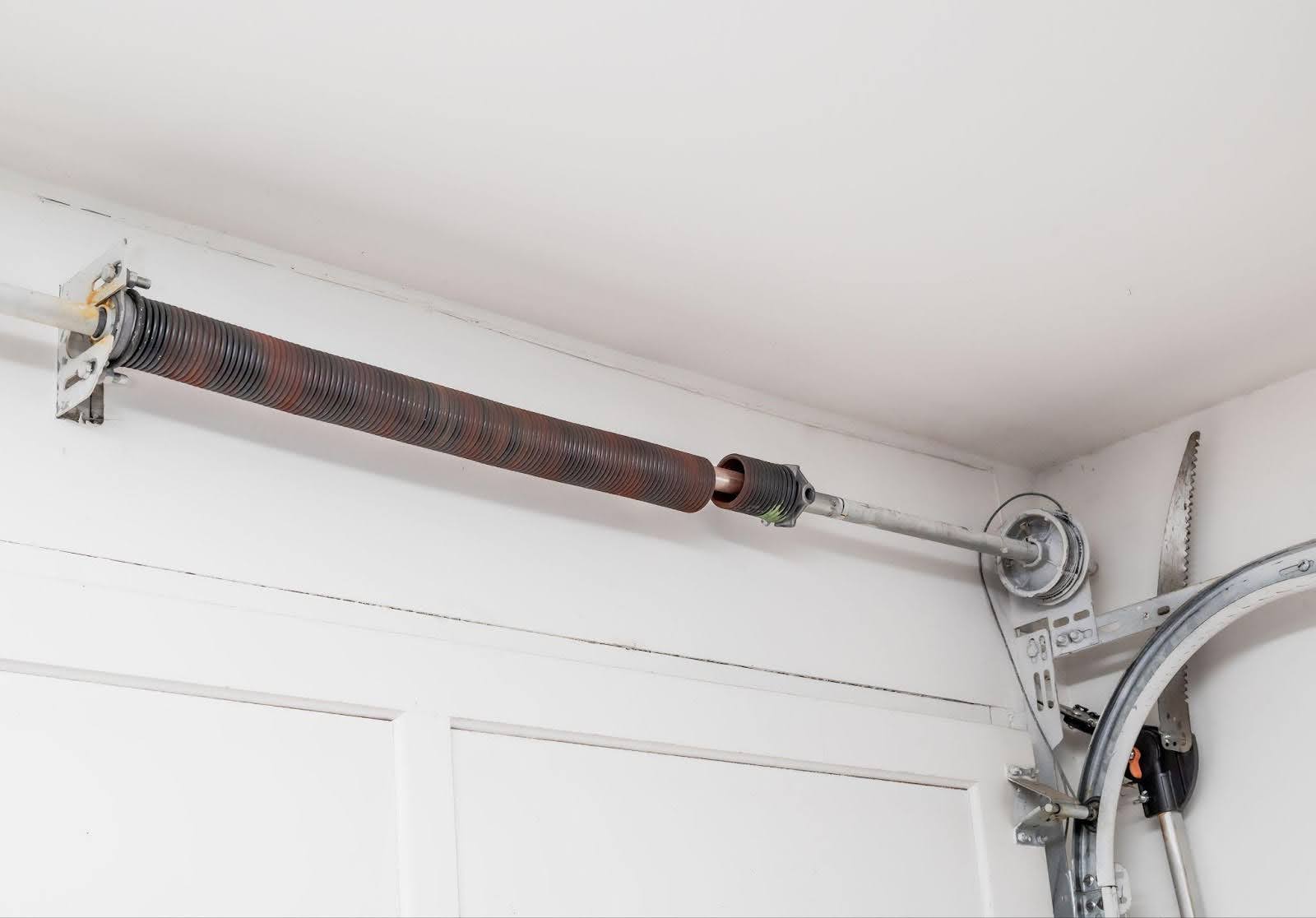 A metal rod on a garage door opener to enhance operation and stability