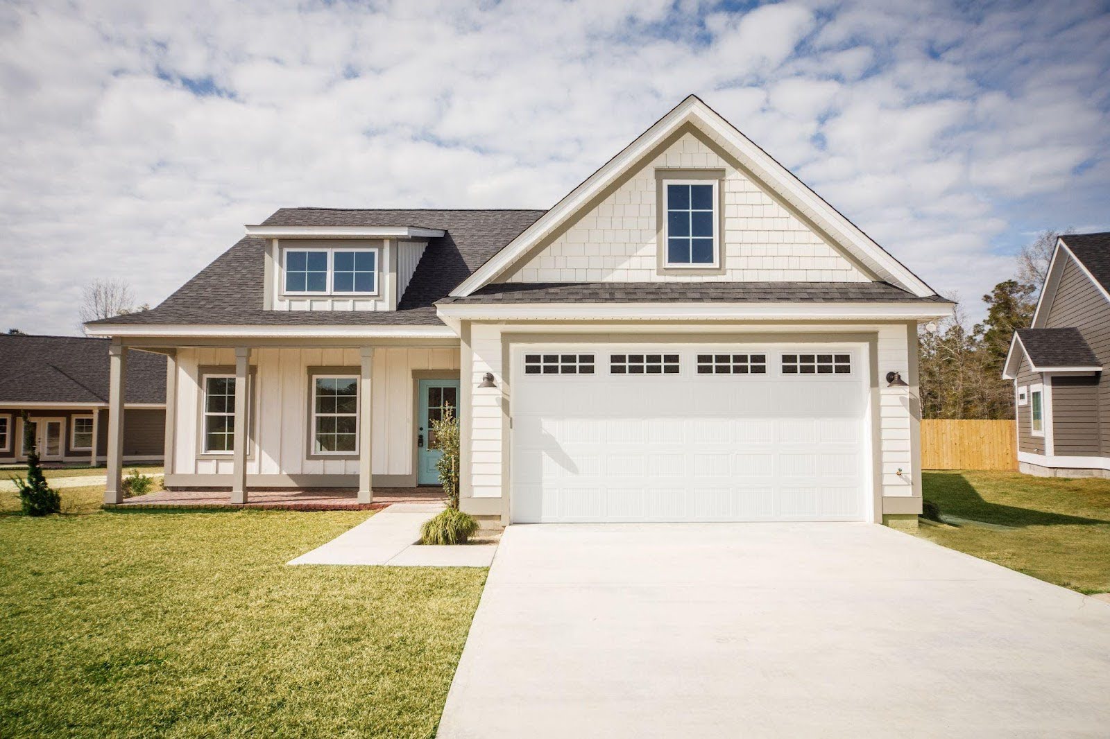 A welcoming home with a garage and paved driveway