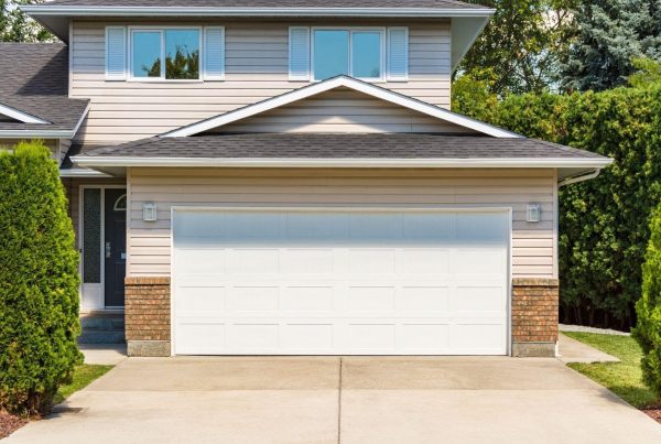 A welcoming home with a garage door and paved driveway