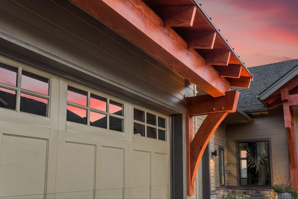 A house with a garage door under a vivid red sky, showcasing a captivating and colorful backdrop