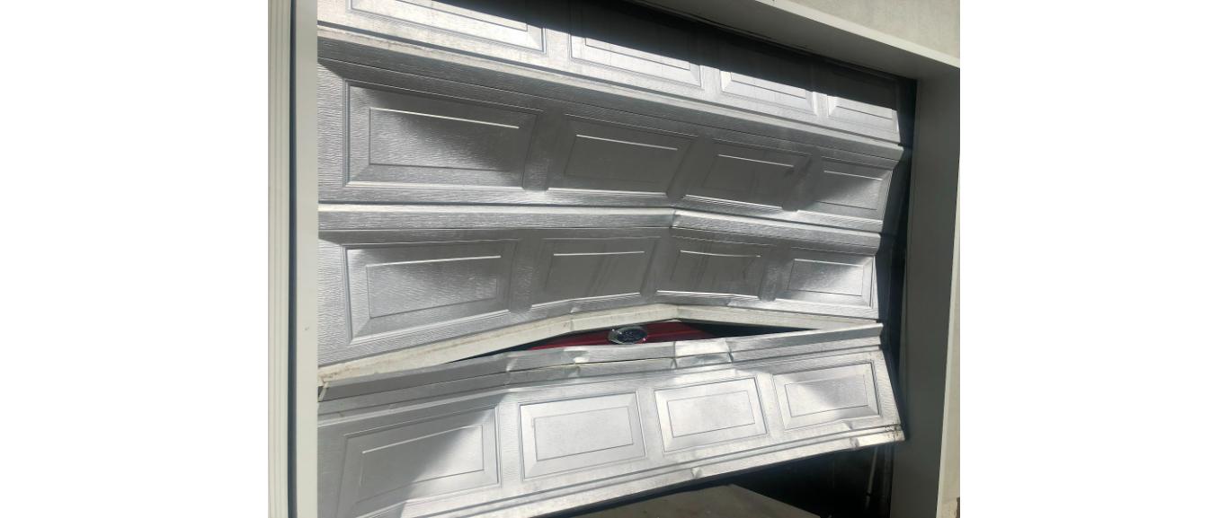 Garage door spring repair Bountiful Utah - panel and spring hardware in need of repair